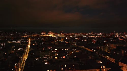 Forwards Fly Above Blocks of Residential Buildings in Large City Illuminated Streets and Buildings