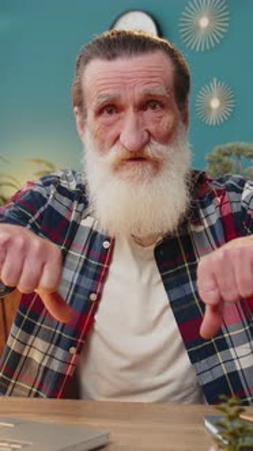 Senior Man Working on Laptop Computer at Home Office Showing Thumbs Down Sign Dislike Disapproval