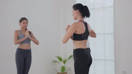 Yoga Instructor Guiding Participants in a Bright Studio