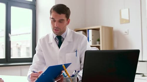 Doctor in Lab Coat Consults Patient at Desk