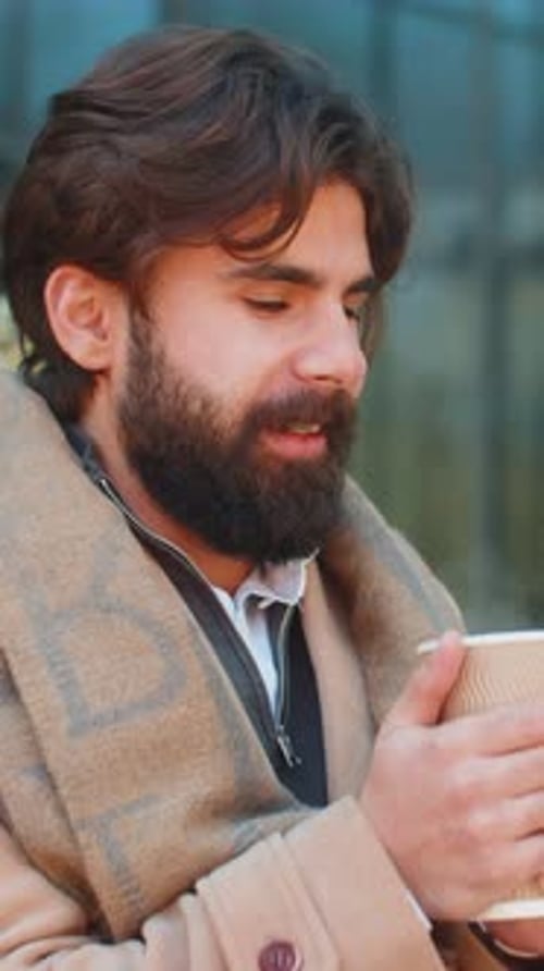 Man Enjoying Coffee Outside on a Cloudy Day