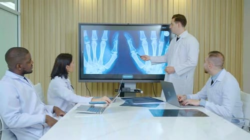 Medical Team Reviews X-Ray During Meeting