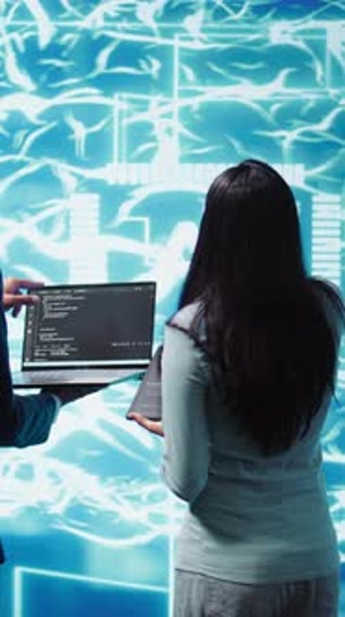 Young Adults Collaborating on Coding Project