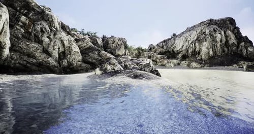 Lush Rocky Coastline Meets Serene Blue Waters Under a Clear Sky