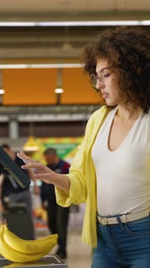 Woman Scanning Bananas at Supermarket Self-Checkout