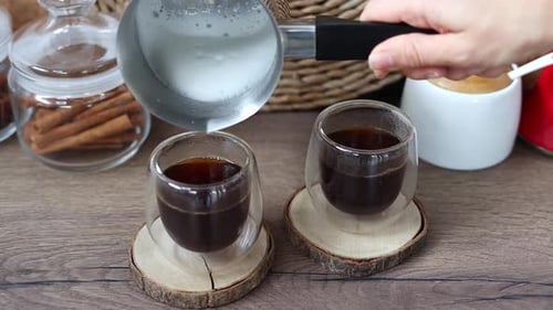 Pouring Steamed Milk Into Coffee For Two