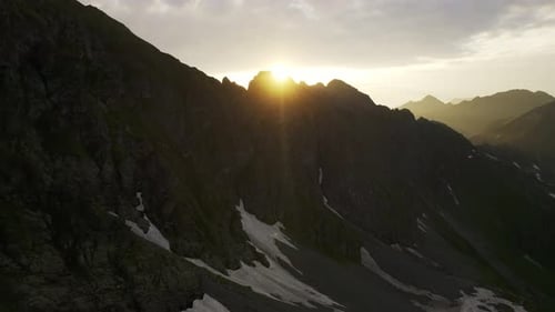 Beautiful sunrise over wild forest mountains in summer morning.