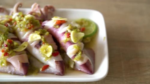 Squid dish on white rectangular plate
