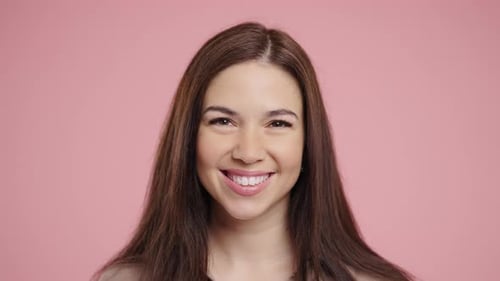 Close Up of Woman Smiling on Pink Background