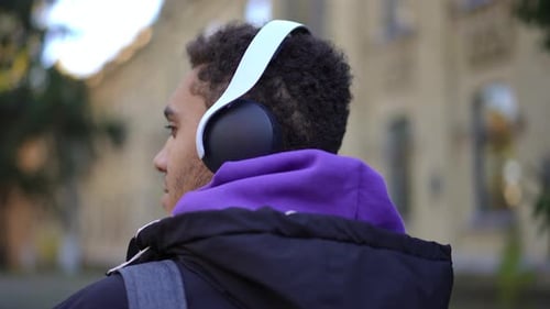 Back View Headshot of Confident Positive African American Young Man Standing at University Campus