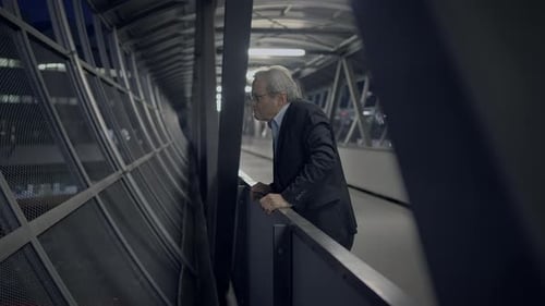 Man Standing on Walkway at Night