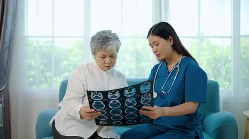 Doctor or nurse and senior patient with mri results in hospital for brain and head injury. Talking