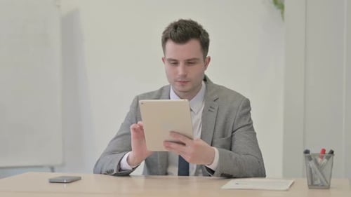 Man Using Tablet in an Office Workplace