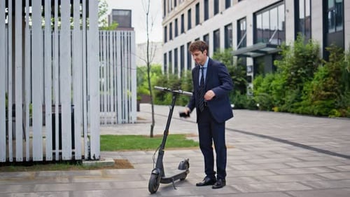 Businessman Taking Electric Scooter in Modern Urban Area Elegant Man Riding