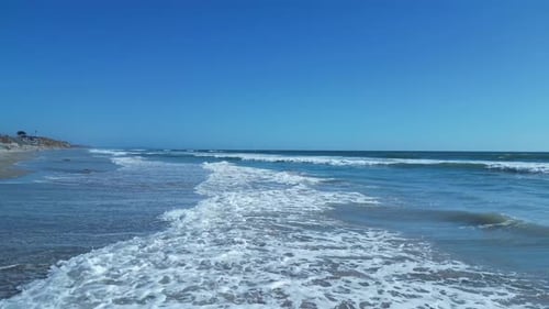 Drone flying over ocean.