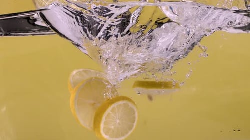 Lemon Slices Falling Into Water With Splash