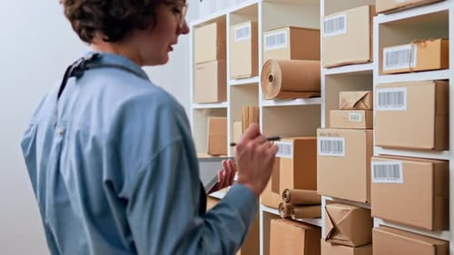 An Employee Of The Parcel Stock Employee Counts The Goods, Checks The Availability, Counts The Boxes