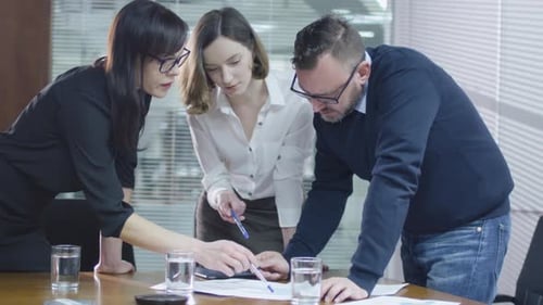 Team Collaborates on Documents in Bright Urban Office