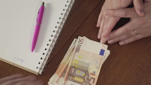 Woman refusing cash bribe by pushing money away on office desk, corruption concept