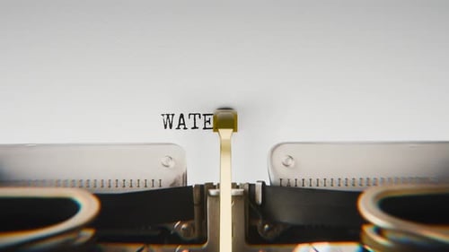 Old mechanical typewriter typing Water Toxins in a close-up view.