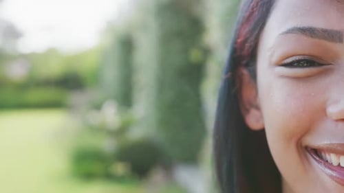 Portrait of happy biracial teenager girl looking at camera with copy space, in slow motion