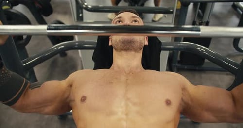 Portrait of a Sporty Caucasian Man Waving His Arms While Lifting a Barbell in the Gym Active Sport