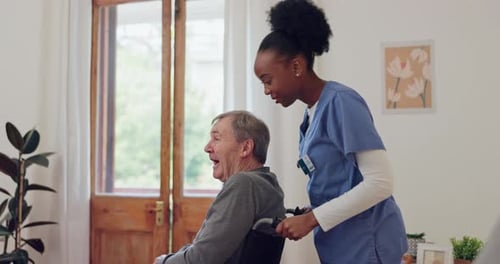Young Woman Pushing Happy Senior Man in Wheelchair