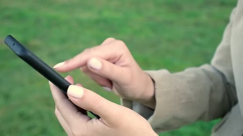 Woman Uses Smartphone in Natural Setting