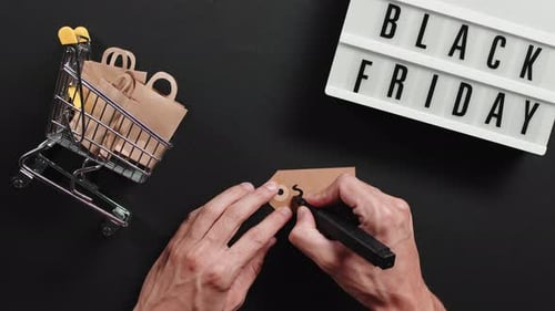 Hand Writes Sale Tag for Black Friday