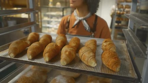 Freshly Baked Croissants in Bakery Rack