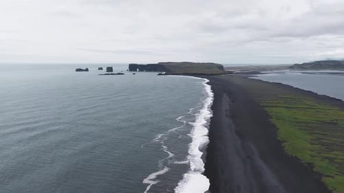 Aerial View of Iceland's Black Sand Beach with Sea Stacks