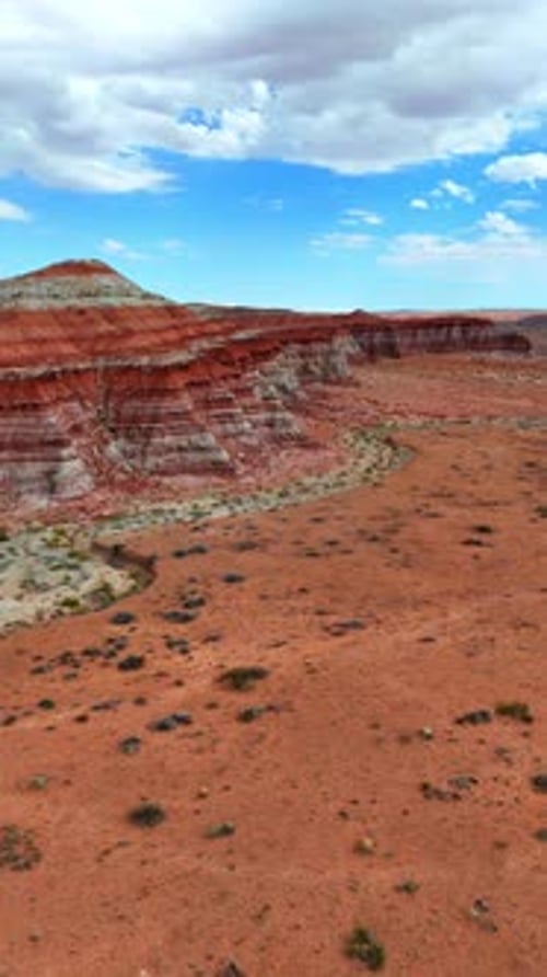 Footage over the desert with scarce vegetation of little shrubs.