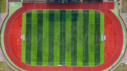 Aerial view from top of soccer field with football player. Football stadium. Outdoor sports