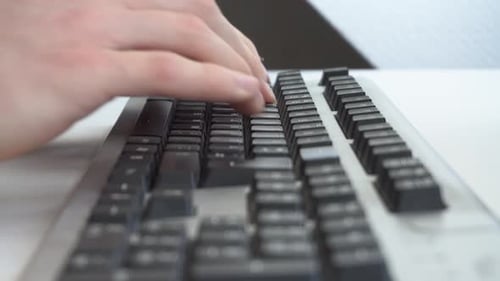 Hands Typing on a Black Computer Keyboard
