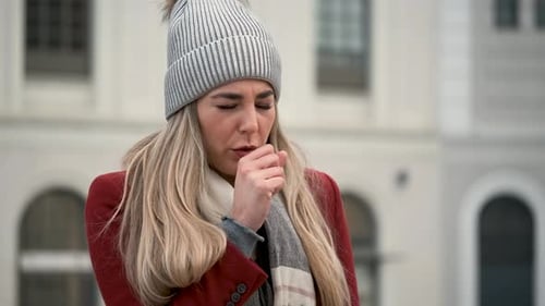 Woman Outside Coughs and Blows Her Nose