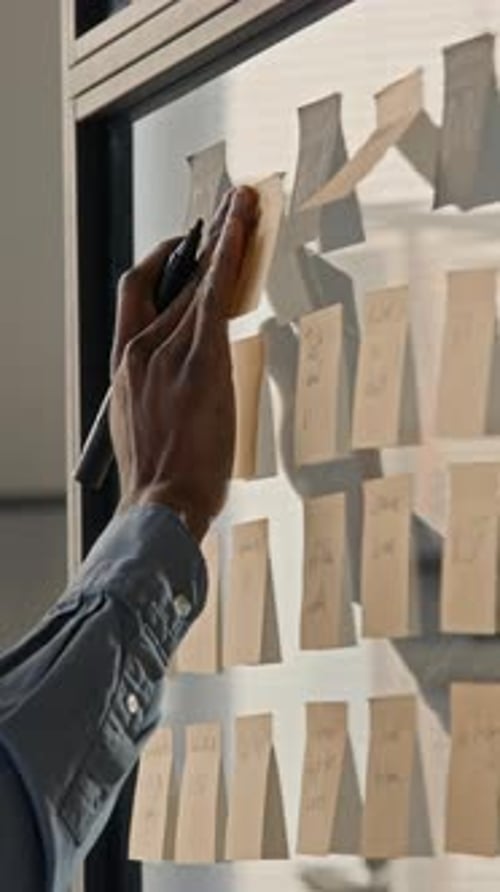 Professional Planning Strategy with Sticky Notes on Office Glass