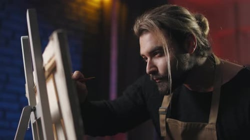 Male Painter Drawing on Canvas at Own Workshop