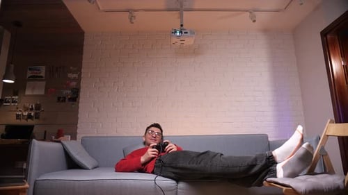 Young Adult Playing Video Game at Home