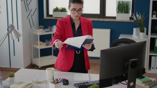 Young Woman Reviews Documents in Bright Office