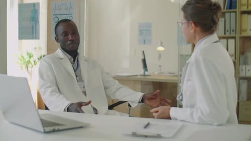 Diverse Doctors Having Discussion in Clinic