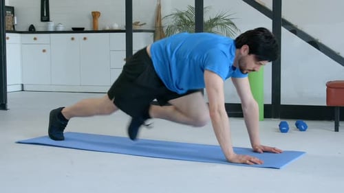 Active Sporty Fitness Man Working Out Mountain Climber Exercise at Home