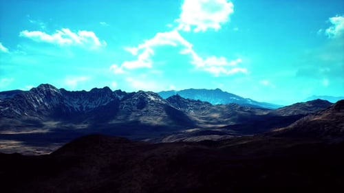 Majestic Mountain Landscape with Dramatic Clouds in a Clear Blue Sky