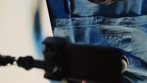 Man Examining Headphones in Studio Setting