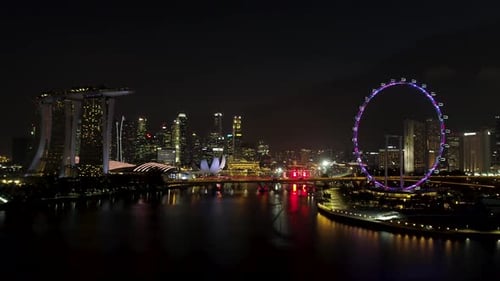 Singapore Skyline at Night Showing Ferris Wheel and Marina Bay Sands Hotel