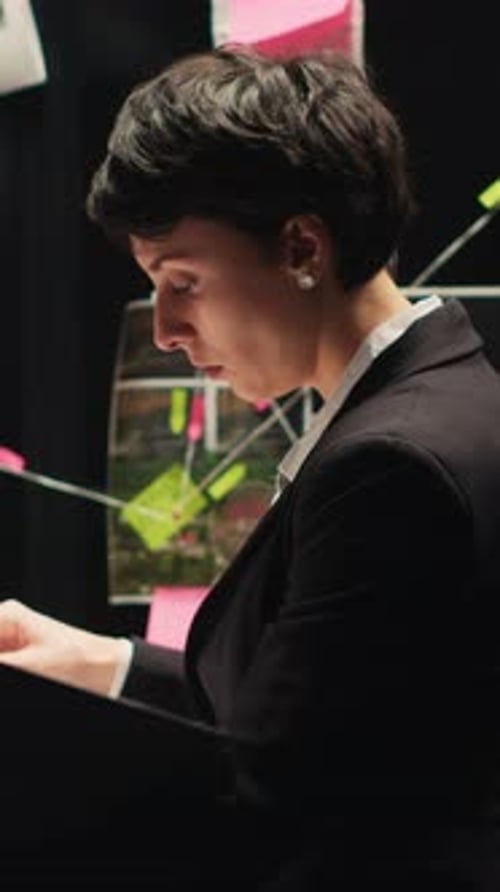 Woman Reviews Documents in Investigation Office Setting