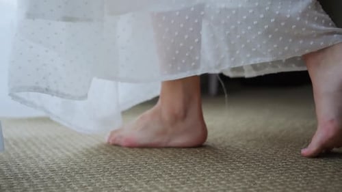 Woman Walking Barefoot Along the Carpet