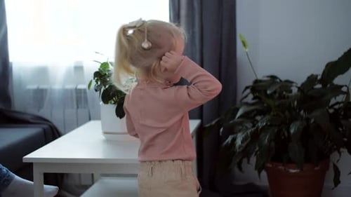 A Girl with a Cochlear Implant Watches TV and Hears Sounds