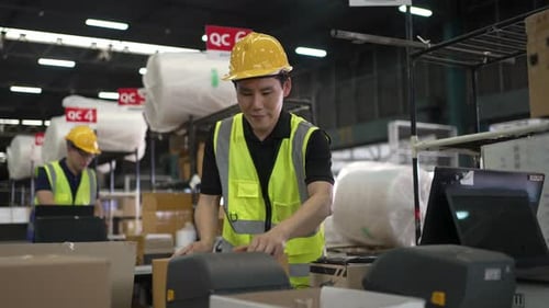 Blue collar workers are working at warehouse.