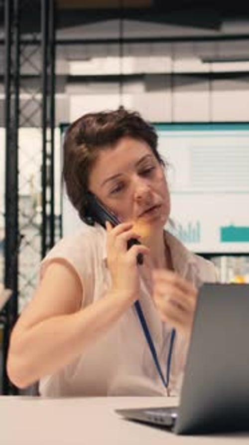 Vertical Video Businesswoman Making Phone Call in Modern Office Reviewing Visual Data