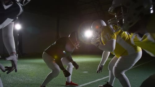 Rival American Football Athletes Crouching against Each Other at Arena